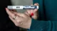 Close-up of a hand holding a Wegovy semaglutide injection pen, prepared for subcutaneous injection.