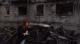 Woman with red hair walks past a burned-out car and ruined brick building.