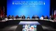 Global summit of officials seated at a long curved table on a blue backdrop with flags, Kyiv 2026 signage behind them.
