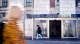A pedestrian walking past a Danske Bank branch storefront