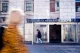 A pedestrian walking past a Danske Bank branch storefront