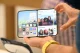 Hands holding an open foldable iPhone Duo showing its inner display