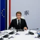 French President Emmanuel Macron sitting at a cabinet meeting table