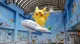 Giant Pikachu balloon riding an airplane balloon in an indoor display